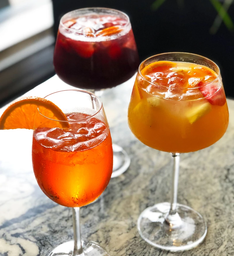 Aperol Spritz with red and white sangria, refreshing cocktails and wine drinks at Symposium Cafe Restaurant and Lounge