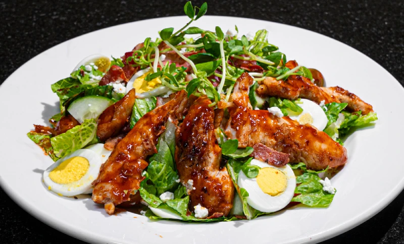BBQ chicken Cobb salad with bacon, egg and goat cheese, a fresh lunch or dinner salad at Symposium Cafe
