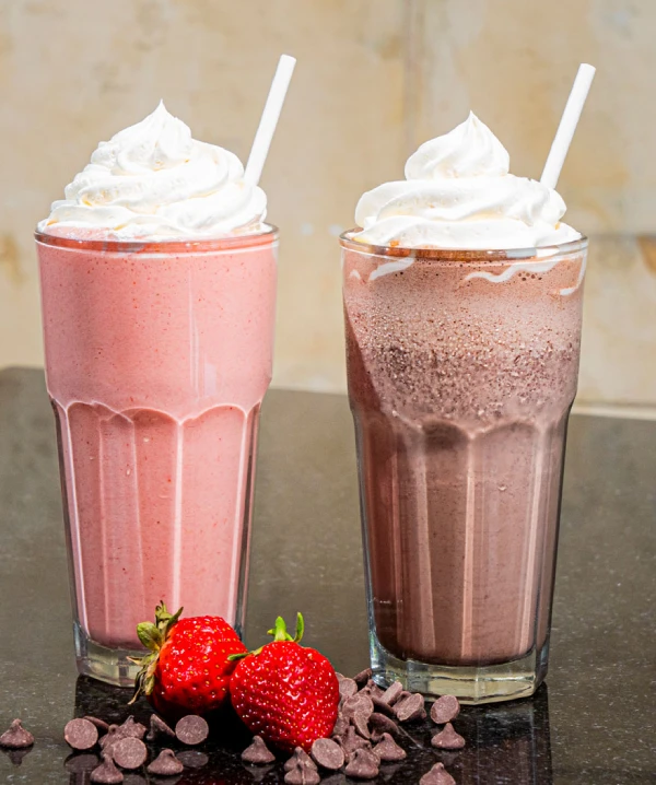 Chocolate and strawberry milkshakes made with real ice cream and whipped cream at Symposium Cafe