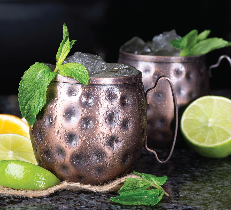 Classic Mule cocktails with ginger beer and lime, refreshing bar drinks at Symposium Cafe Restaurant and Lounge