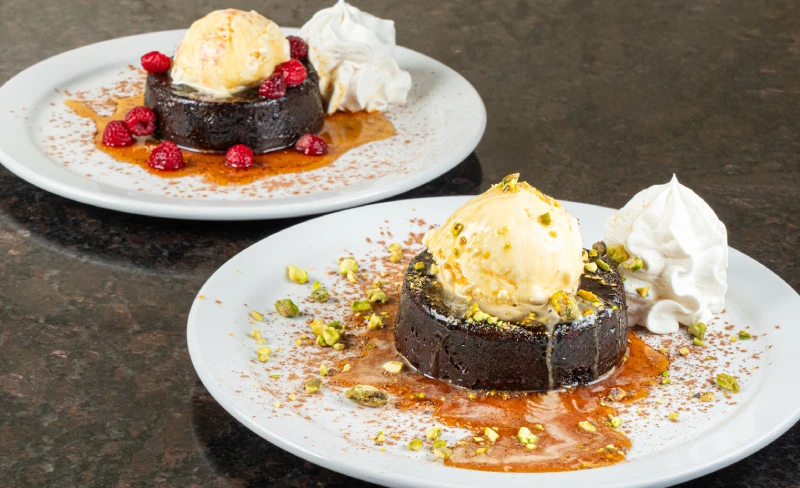 Dessert spot offering Dubai chocolate raspberry and pistachio lava cakes, rich specialty desserts at Symposium Cafe