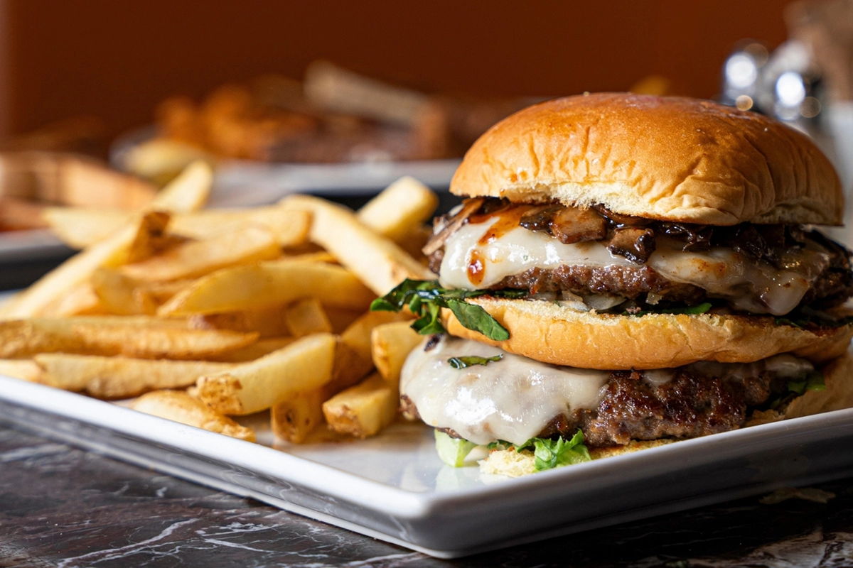 Mushroom Double Swiss burger with premium ground chuck, sautéed mushrooms and melted Swiss cheese at Symposium Cafe.