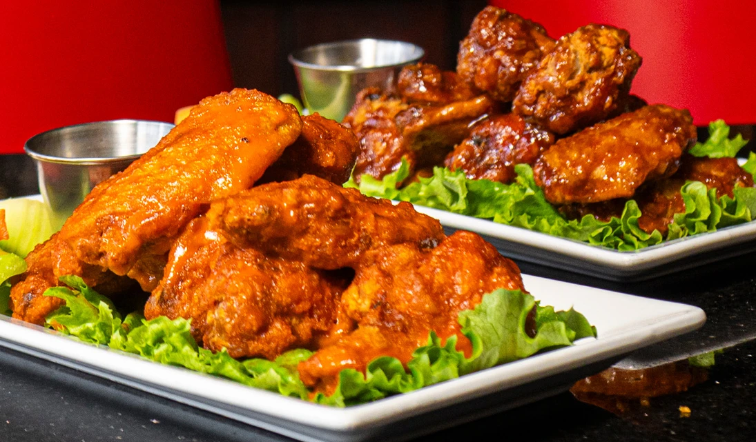 Crispy halal chicken wings with dipping sauce, a signature lunch and dinner appetizer at Symposium Cafe