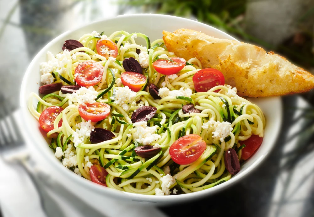 Vegetarian zucchini noodles with feta, tomatoes and olives, a lighter lunch or dinner entrée at Symposium Cafe