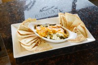 ontario restaurants best lunch near me serving a spinach dip loaded with feta and cheddar, side of pita at symposium caf