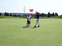 young golfer putting for charity