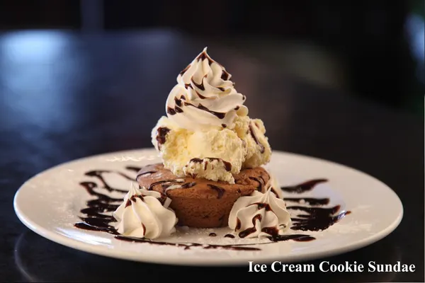 Warm pan-baked cookie sundae with creamy ice cream and chocolate sauce at Symposium Cafe Restaurants.