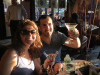 couple celebrating with martinis on symposium cafe restaurants patio