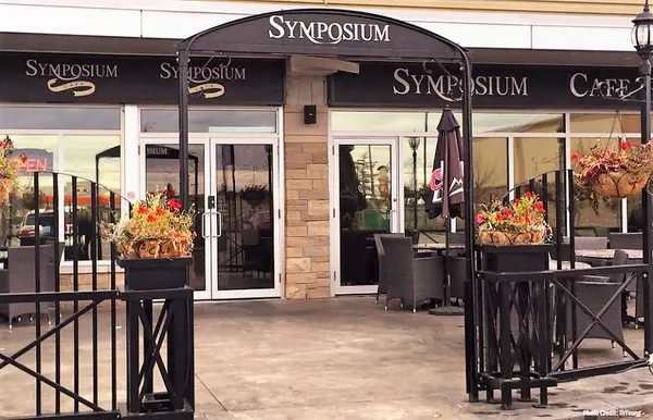 Symposium Cafe Restaurant Stoney Creek patio with comfortable outdoor seating and a welcoming atmosphere.