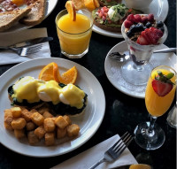 The signature Eggs Benjamin breakfast at Symposium Cafe Ajax, served with crispy breakfast potatoes, fresh orange juice,