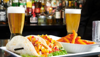 A fresh fish tacos lunch with fries and a $5 happy hour draught beer at Symposium Cafe Aurora, located on Hollandview Tr