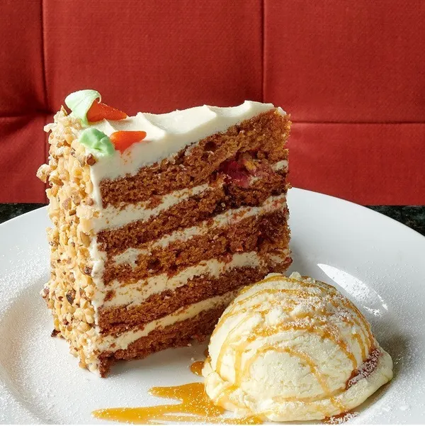 Waterloo dessert restaurant serving a tall slice of signature Sky-High Carrot Cake.