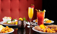 A signature selection of brunch cocktails in Ajax, featuring a classic Mimosa, a loaded Caesar, and a Moscow Mule cockta