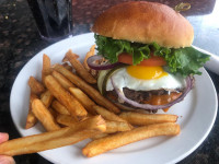 markham breakfast burger with a sunny side up egg fries at symposium cafe