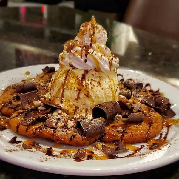 Late-night dessert in Thornhill with a warm pan-baked cookie, creamy ice cream, chocolate chips and rich sauces.
