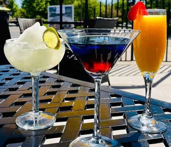 Patio cocktails with martinis, mimosas and margaritas for relaxed outdoor dining at Symposium Cafe.