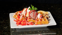 ontario restaurants dessert, hot waffle topped with chocolate ice-cream and fresh strawberries dessert symposium cafe ne