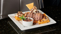 ontario restaurants dessert, hot waffle topped with chocolate ice-cream, and nutella drizzle dessert at symposium cafe