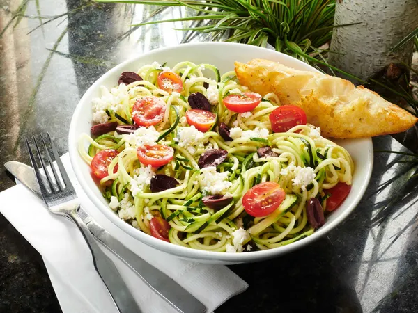Symposium Cafe vegetarian favourite with fresh zucchini noodles, tomatoes, olives and creamy feta.