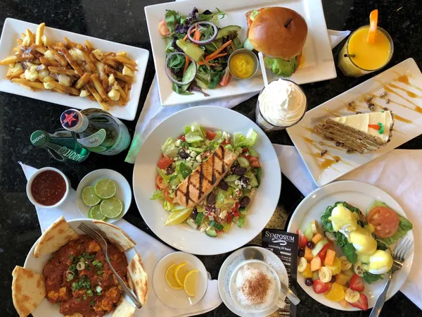 Symposium Cafe weekend food spread with burger, butter chicken, salmon, poutine and shareable favourites.