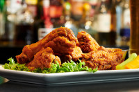 Our popular half-price Wednesday wings special in Ajax featuring crispy, saucy chicken wings at Symposium Cafe near Ross
