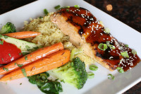 A grilled salmon dinner with rice and veggies at Symposium Cafe Aurora, featuring our Friday seafood special with free c