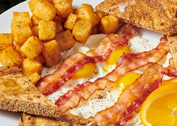 Family breakfast in Markham with eggs, crispy bacon, golden home fries and warm toast.
