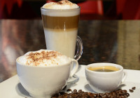 A flight of our best specialty coffees in Ajax, featuring a rich espresso, a smooth latte with latte art, and a classic 