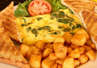 A fresh three-egg veggie omelette loaded with garden vegetables and served with crispy breakfast potatoes at Symposium C