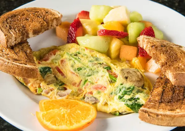 Bolton breakfast place serving a fluffy vegetable omelette with fresh fruit, toast and hearty sides.