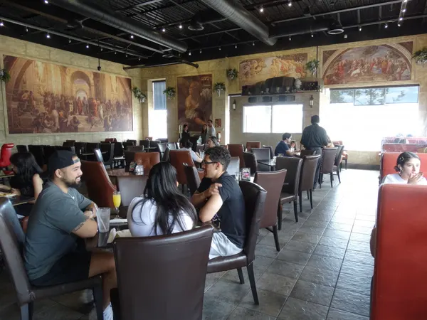 The beautiful dining room at Symposium Cafe Ajax, featuring comfy seating, cozy ambiance, and elegant decor