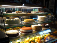 cake showcase showing over a dozen cakes at symposium cafe desserts restaurant