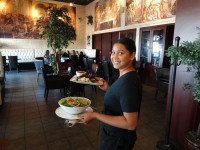 mississauga restaurants indoor dining photo showing server and beautiful interiors at symposium cafe