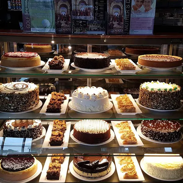 Gourmet cake and cheesecake display at Symposium Cafe Restaurant Oakville