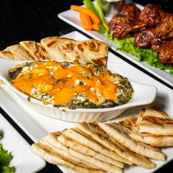 Spinach dip with warm pita and chicken wings at Symposium Cafe Oakville