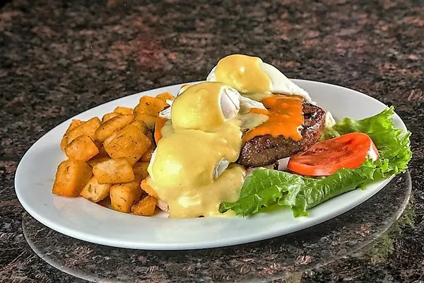 Thornhill breakfast spot serving Eggs Benedict with seasoned breakfast potatoes at Symposium Restaurant