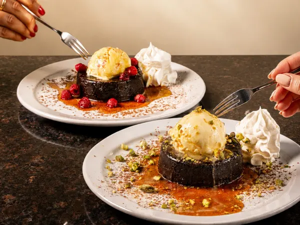 Thornhill signature desserts featuring warm chocolate lava cakes with vanilla ice cream, raspberries and pistachios at S