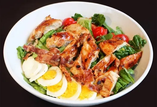 Oakville Ontario restaurant healthy entrees showcasing our BBQ Chicken Cobb Salad part of our dinner menu at Symposium Cafe.