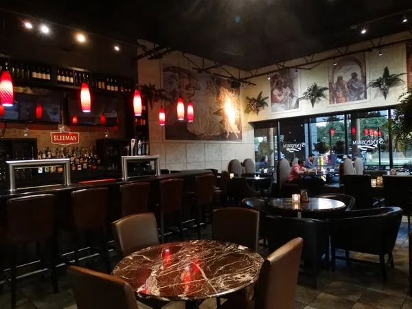 Oakville Ontario restaurant bar and lounge interior with licensed full bar, marble tables and Renaissance artwork at Symposium Cafe
