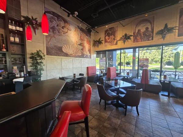 Oakville Ontario restaurant lounge interior with comfortable seating, large windows and Renaissance-themed murals at Symposium Cafe