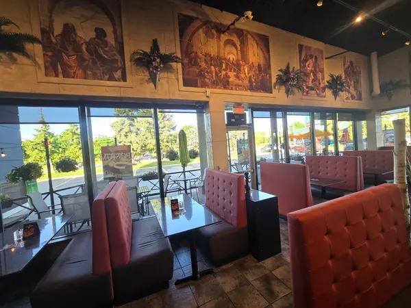 Oakville Ontario restaurant dining room near me with booth seating, bright windows and Renaissance murals at Symposium Cafe