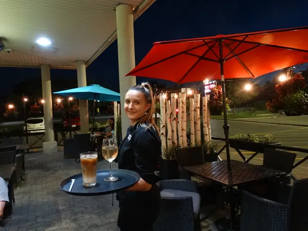 Oakville Ontario restaurant patio with full service drinks and cocktails served for evening outdoor dining at Symposium Cafe