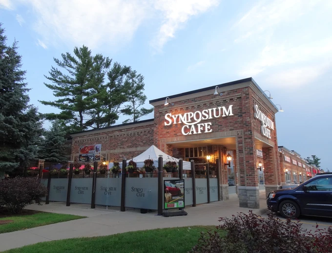 Symposium Cafe Restaurant Alliston family restaurant exterior facade and outdoor patio seating located on Young Street in the Alliston Market Village Shopping Mall, next to Good Life Fitness.