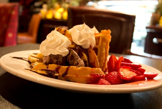 Ice Cream Waffles with Strawberries and Chocolate icecream one of the amazing desserts at Symposium Cafe Restaurant Ancaster