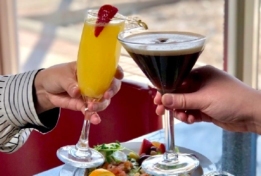 Martini and Mimosa Cocktail Special celebration toast at at Symposium Cafe Restaurant Ancaster, a family restaurant serving up great weekend brunch cocktail specials