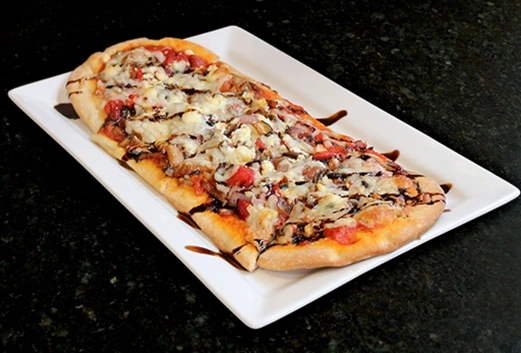 Bruschetta Flatbread appetizer at Symposium Cafe Restaurant Ancaster, a family restaurant serving up gourmet comfort food for lunch, dinner and late night dining.