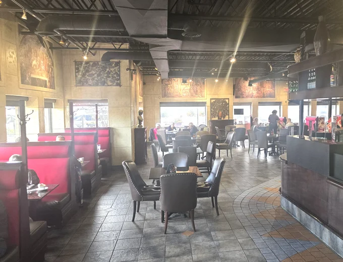 Stylish interior of Symposium Cafe Restaurant Brantford showing the cozy cafe area, Renaissance-style decor, and comfortable seating for large groups and families located near Northridge Public Golf Course & Lynden Park Mall.