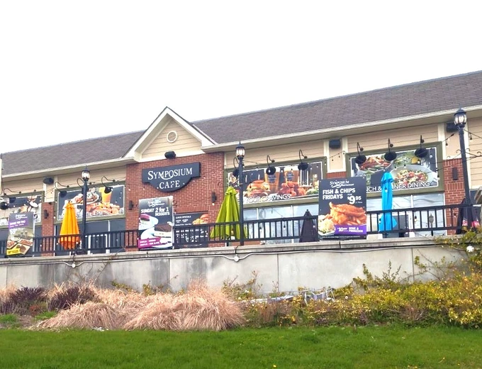 Symposium Cafe Restaurant Cambridge family restaurant exterior facade and outdoor patio seating located on Can-Amera Parkway off of Townline Road minutes from the 401 and the Cambridge Centre Mall.