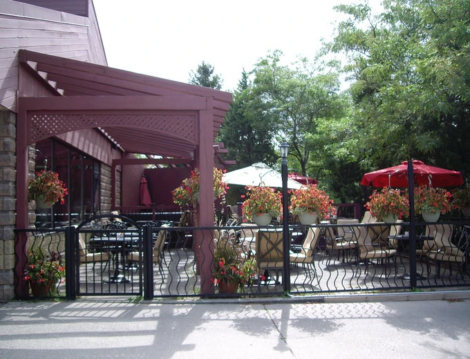 Symposium Cafe Restaurant Guelph family restaurant exterior facade and outdoor patio seating located across Stone Road Mall and nearby University of Guelph at 304 Stone Road West.