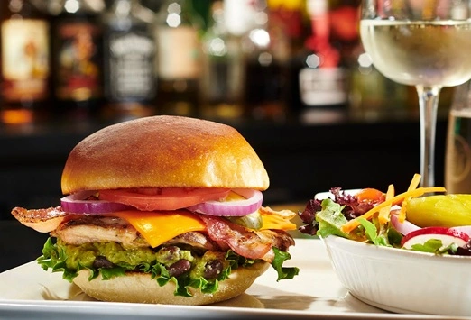 California Chicken Sandwich with guacamole and cheese at Symposium Cafe Restaurant Lindsay, a family restaurant serving up gourmet comfort food for lunch, dinner and late night dining.